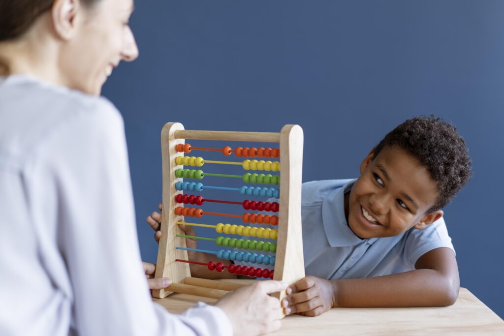 little boy having occupational therapy session with psychologist