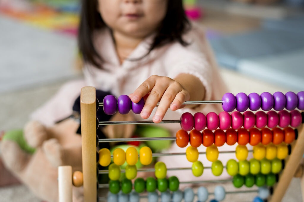 little girl playing abacus counting practice